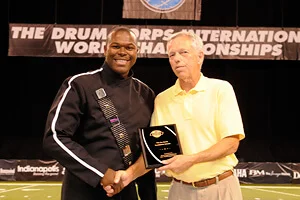 DaJuan Brooks with DCI Hall of Fame member Gene Monterastelli.' caption-winning color guard celebrates on Sunday in Rochester, N.Y. 