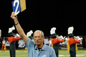 A member of the DCI contest crew keeps track of the performing corps' warm-up time.